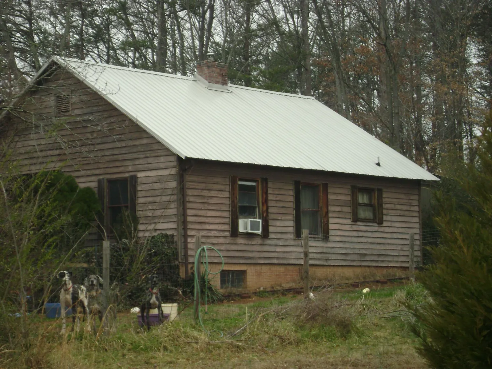White metal roof on an old wood sided farmhouse, from a Metal Roof Installation job in Zwingle